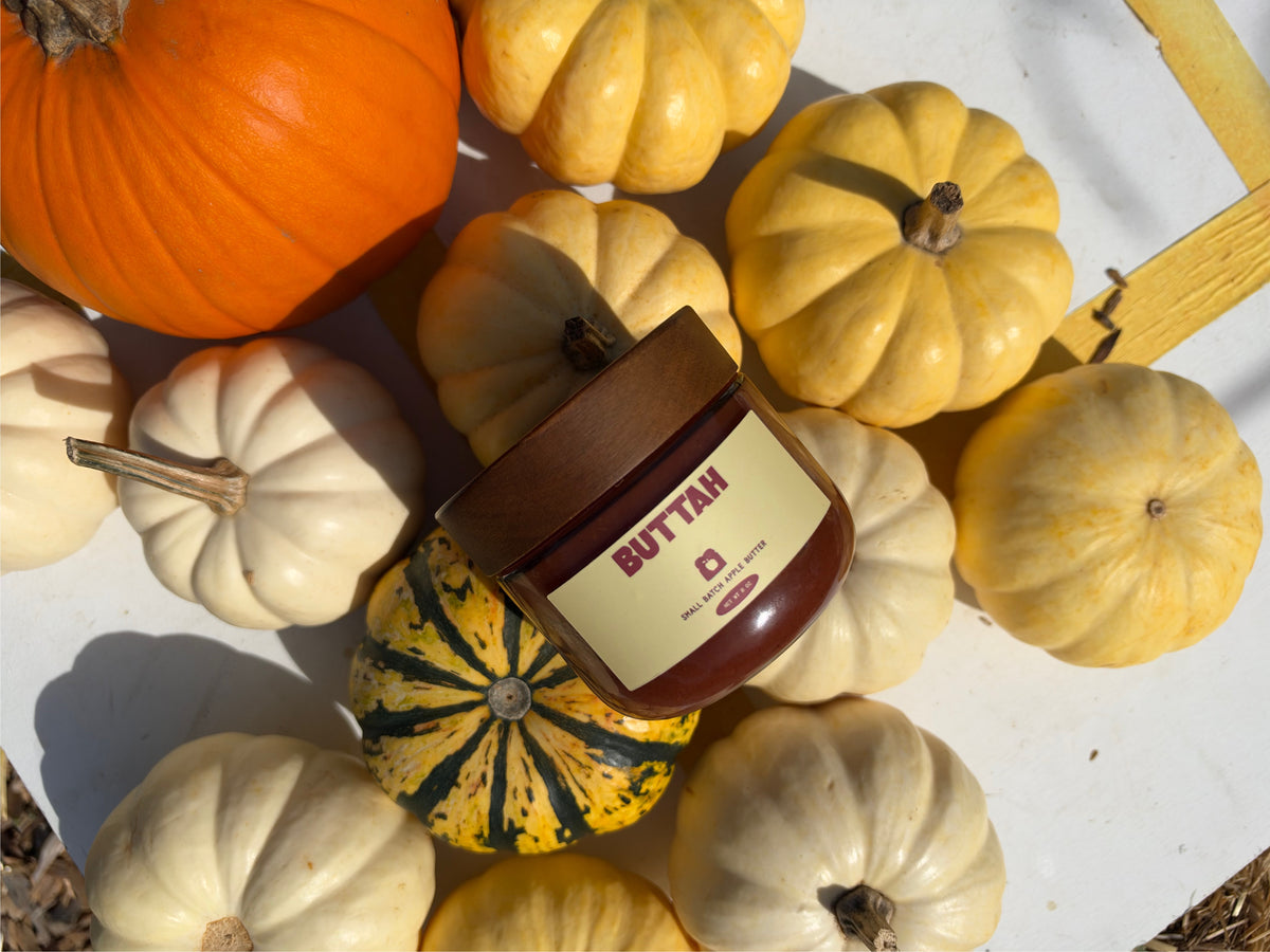 Buttah apple butter jar nestled among autumn pumpkins