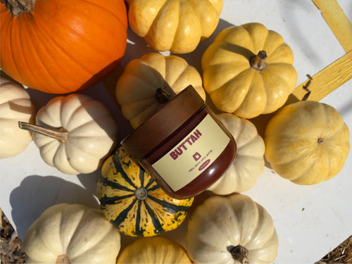 Buttah apple butter jar nestled among autumn pumpkins